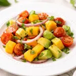 Vibrant avocado mango salad with fresh ingredients like mangoes, avocados, and lime dressing.